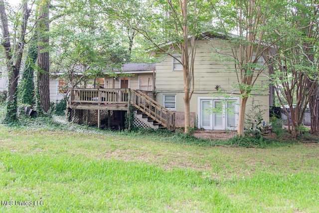 1777 Brecon Dr, Jackson, MS 39211 - rear view of house with a wooden deck, stairway, and a yard