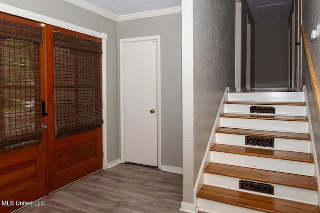 1777 Brecon Dr, Jackson, MS 39211 - staircase featuring a textured wall, wood finished floors, ornamental molding, baseboards, and attic access