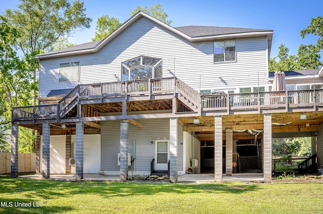 back of property featuring a patio area, a deck, and a lawn
