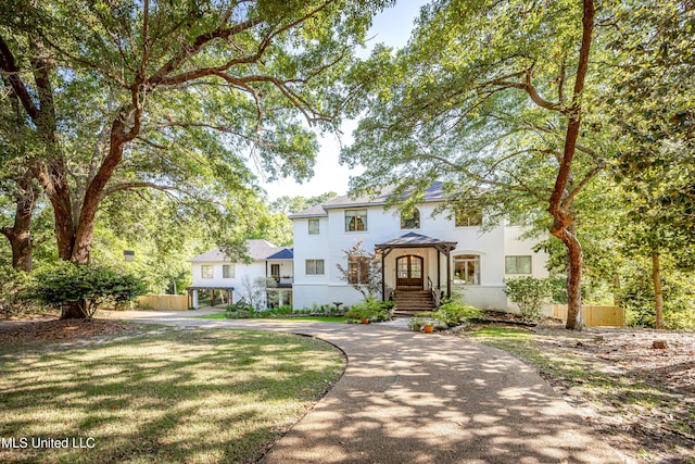 view of front facade featuring fence and stucco siding