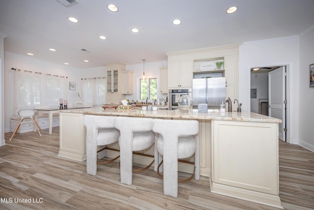 kitchen with recessed lighting, a kitchen breakfast bar, and appliances with stainless steel finishes