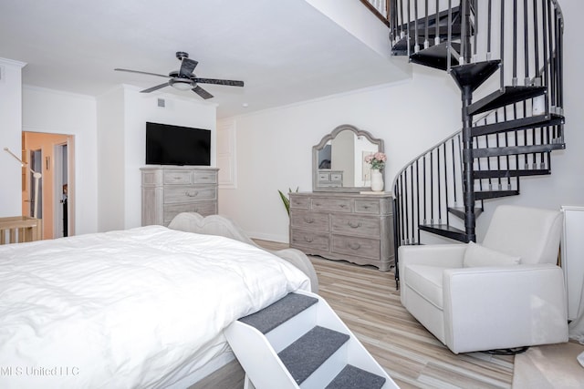 bedroom with a ceiling fan, ornamental molding, and wood finished floors