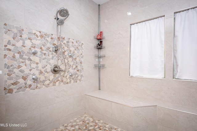 full bath with tiled shower