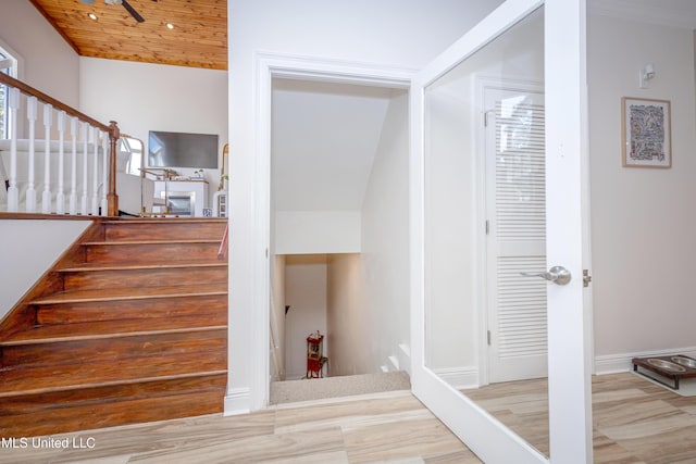 stairs featuring wooden ceiling and lofted ceiling