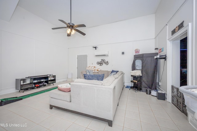 living room featuring a decorative wall, light tile patterned flooring, high vaulted ceiling, a wall unit AC, and a ceiling fan
