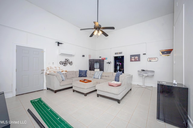 living area featuring light tile patterned floors, a wall mounted air conditioner, ceiling fan, and a towering ceiling