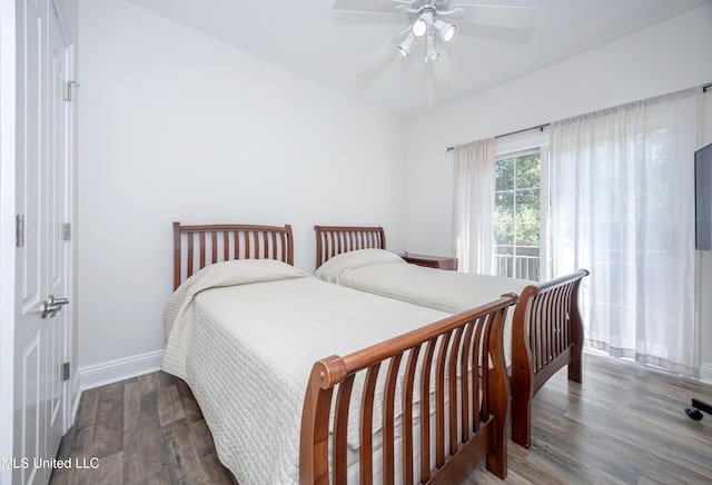 bedroom with baseboards, ceiling fan, and wood finished floors