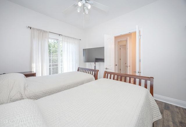 bedroom featuring baseboards, ceiling fan, and wood finished floors