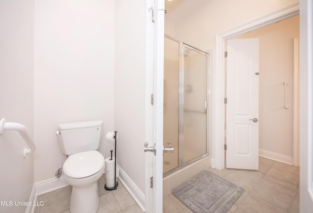bathroom with tile patterned floors, baseboards, and a shower stall