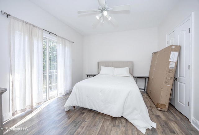bedroom with access to outside, wood finished floors, and ceiling fan