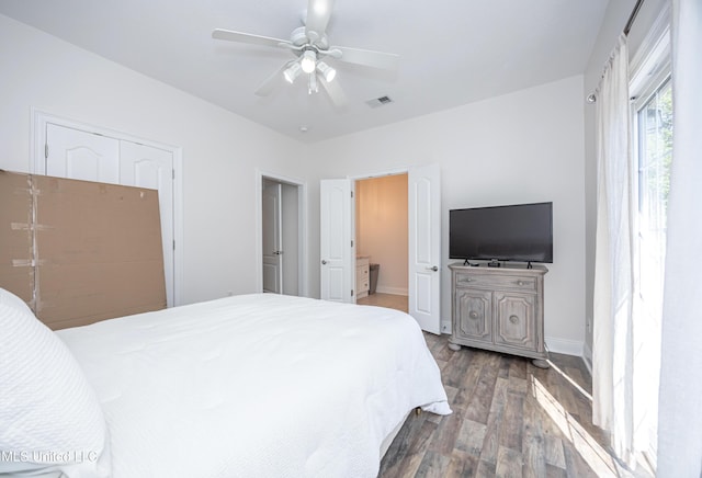 bedroom featuring a ceiling fan, visible vents, wood finished floors, and baseboards