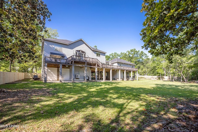rear view of property with a fenced backyard, a wooden deck, and a lawn