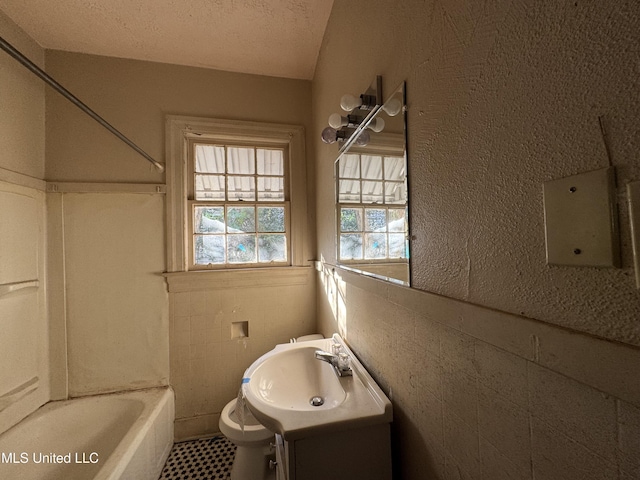 full bathroom with toilet, vanity, shower / washtub combination, and a textured ceiling