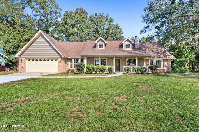 cape cod-style house featuring covered porch, a front lawn, and a garage