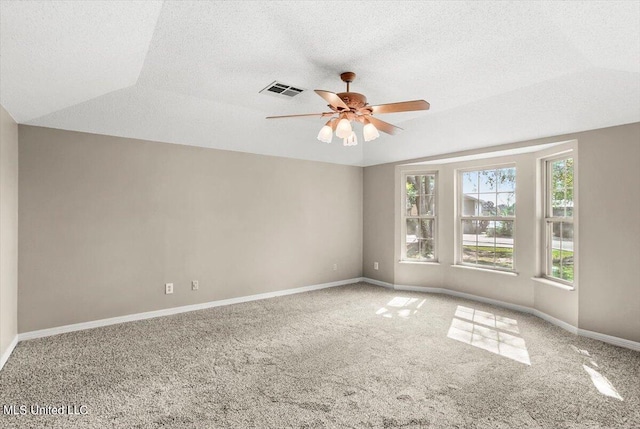 carpeted empty room with lofted ceiling, a textured ceiling, and ceiling fan