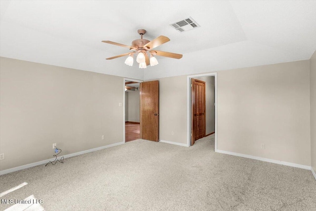 carpeted spare room featuring ceiling fan