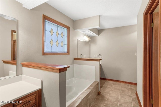 bathroom featuring vanity, tiled tub, and tile patterned floors