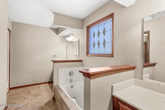 bathroom with vanity, tiled bath, and tile patterned floors