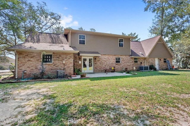 back of house with french doors, a patio, a lawn, and cooling unit