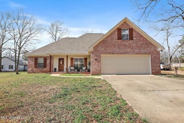 view of front of home featuring a garage, a front yard, and covered porch