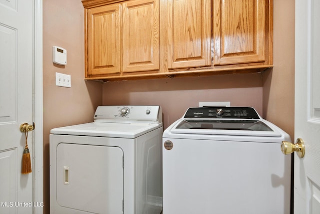 laundry area featuring independent washer and dryer and cabinets