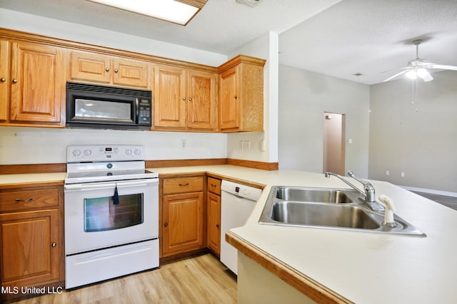 kitchen featuring white appliances, sink, light wood-type flooring, kitchen peninsula, and ceiling fan