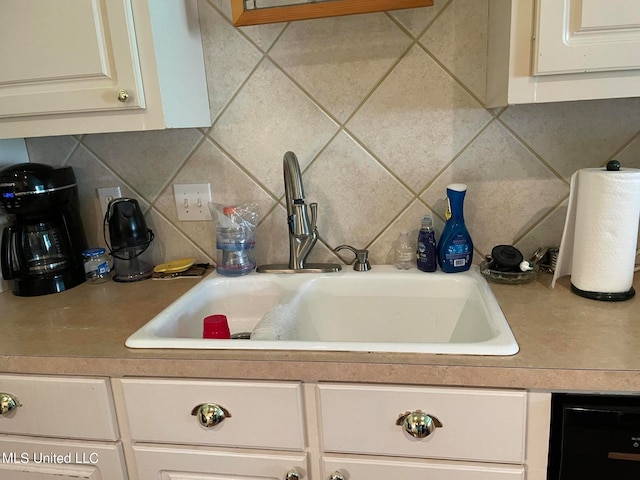 kitchen with sink, dishwasher, and tasteful backsplash