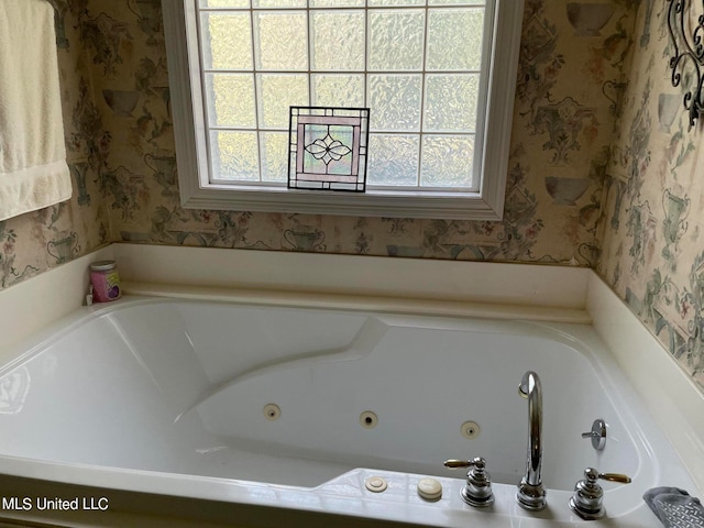 bathroom with a healthy amount of sunlight and a bath