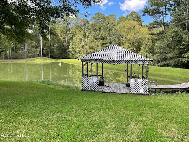 view of dock featuring a gazebo, a water view, and a lawn