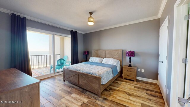 bedroom featuring ornamental molding, access to outside, baseboards, and wood finished floors