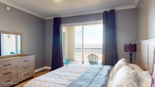 bedroom with access to outside, ornamental molding, a water view, and wood finished floors