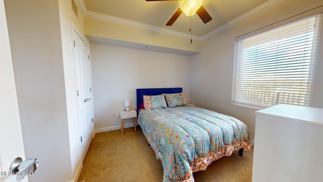 carpeted bedroom with ornamental molding, ceiling fan, and baseboards