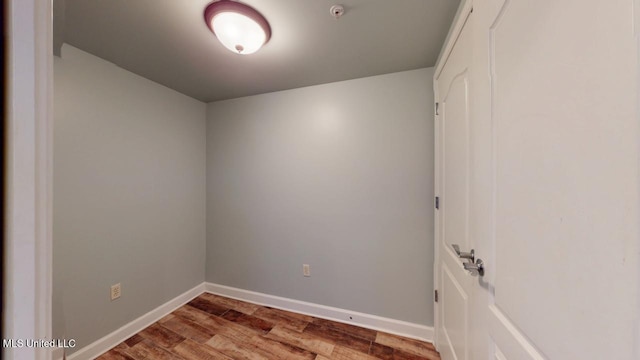 empty room featuring baseboards and wood finished floors