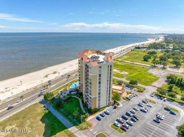 birds eye view of property featuring a beach view and a water view