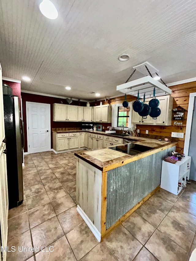 31019 N 19th Hwy, West, MS 39192 - kitchen with freestanding refrigerator, dark countertops, a peninsula, and light tile patterned floors
