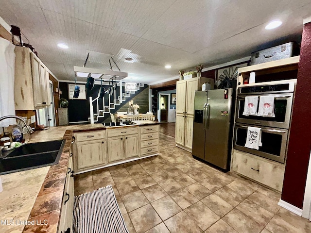 31019 N 19th Hwy, West, MS 39192 - kitchen with a sink, a peninsula, cream cabinets, tile patterned flooring, and appliances with stainless steel finishes