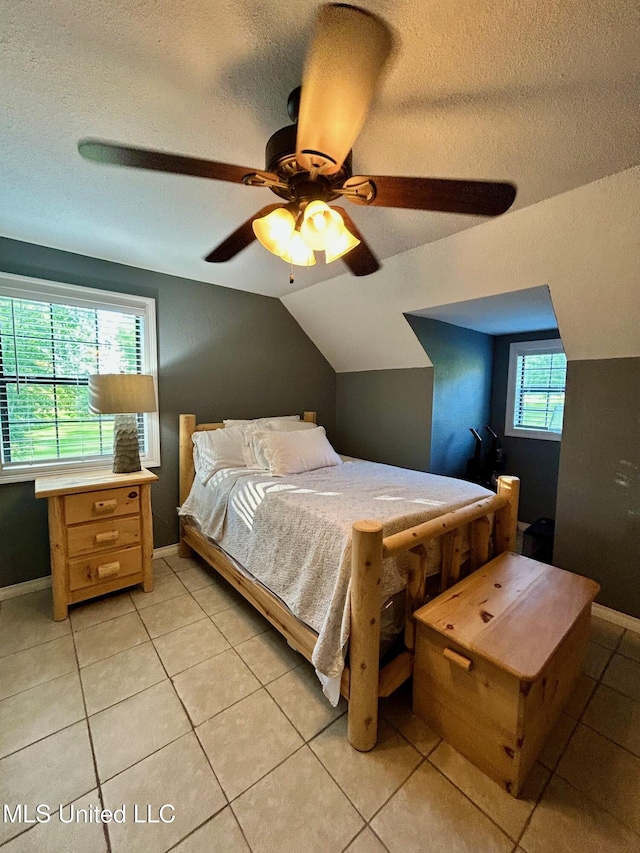 31019 N 19th Hwy, West, MS 39192 - bedroom with light tile patterned floors, a textured ceiling, baseboards, ceiling fan, and vaulted ceiling