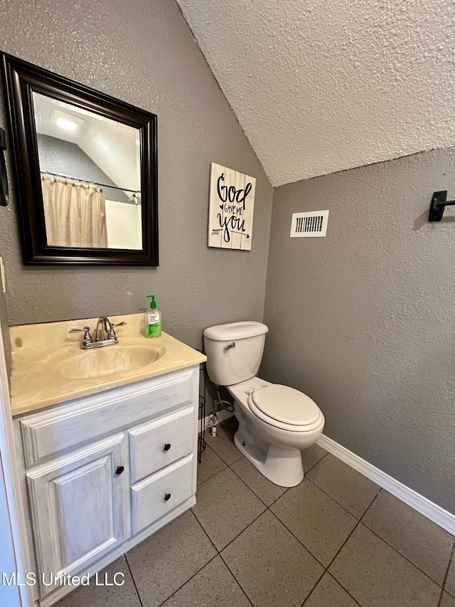 31019 N 19th Hwy, West, MS 39192 - bathroom with toilet, visible vents, baseboards, lofted ceiling, and vanity