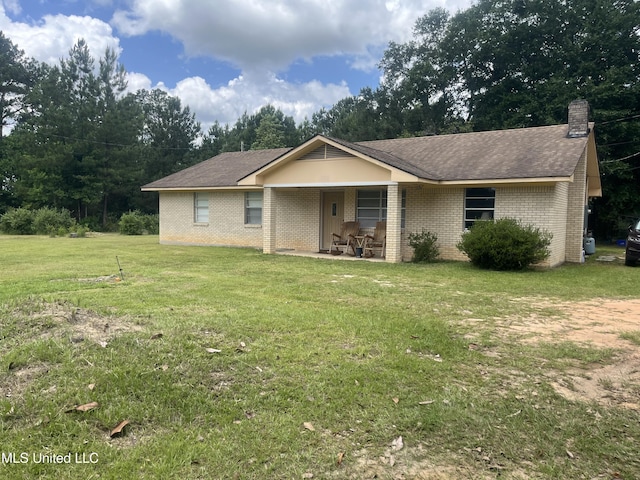 23601 Hinton Rd, Lucedale, MS 39452 - ranch-style house with brick siding, a front yard, a chimney, and roof with shingles