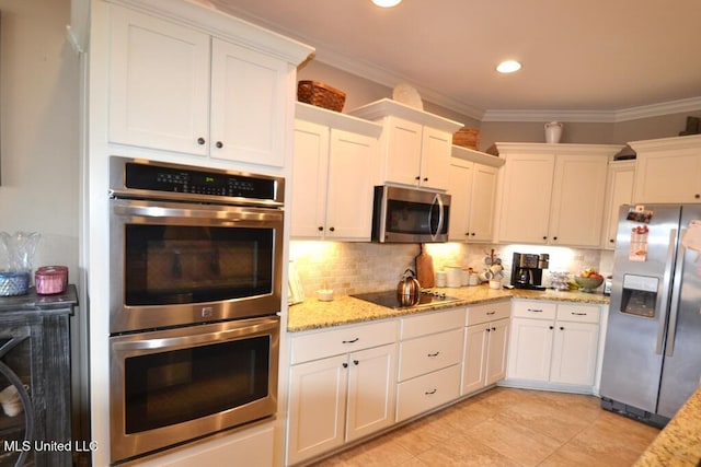 kitchen with stainless steel appliances, white cabinetry, and ornamental molding