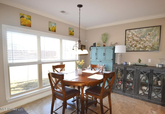 dining space with light tile patterned floors, ornamental molding, and visible vents