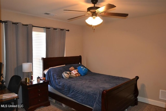 bedroom with baseboards, visible vents, and a ceiling fan