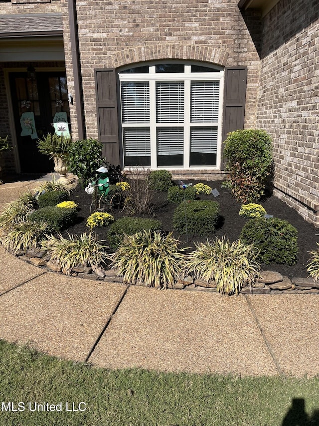 exterior details featuring brick siding