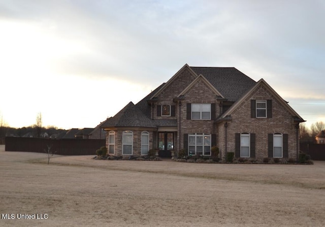 view of front of property featuring a front yard and brick siding