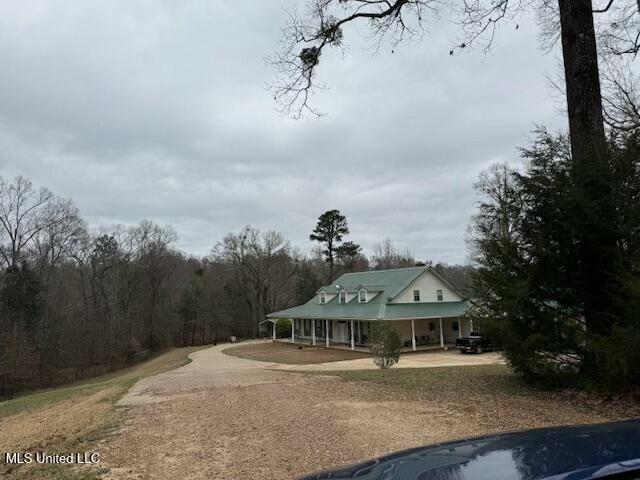 exterior space with a wooded view