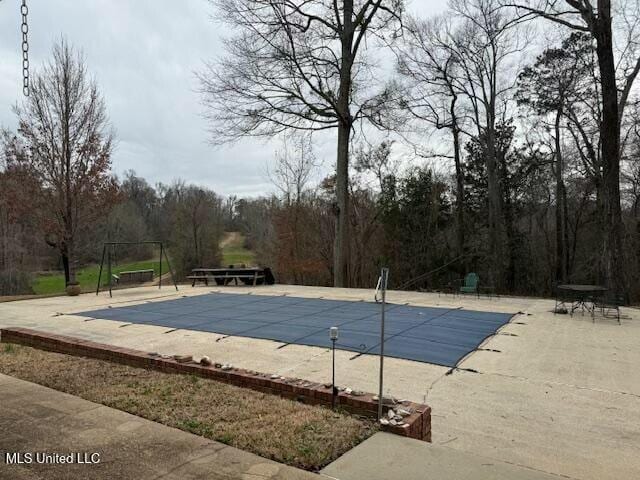 view of pool with a patio area and a covered pool