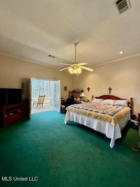 carpeted bedroom featuring access to exterior, a ceiling fan, visible vents, and crown molding