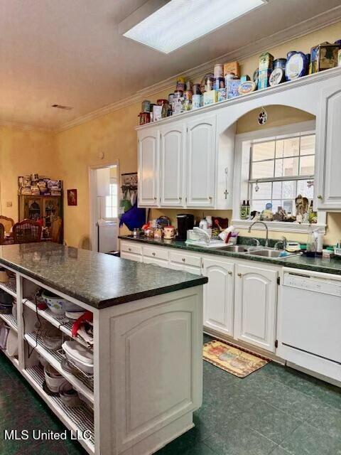 kitchen with white cabinets, dark countertops, ornamental molding, white dishwasher, and open shelves