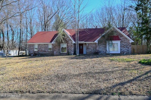 single story home featuring fence and brick siding