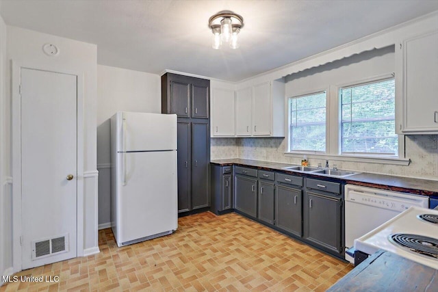 722 SE 1st St, Magee, MS 39111 - kitchen featuring visible vents, a sink, brick patterned floor, and white appliances